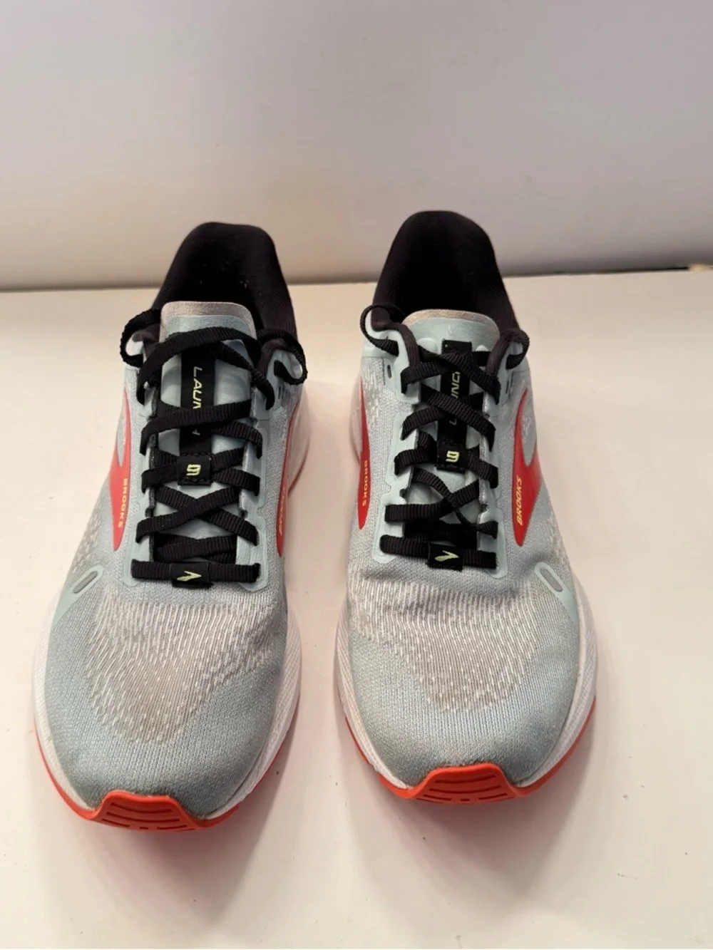 Brooks Light Gray Running Shoes with Red and Orange Accents